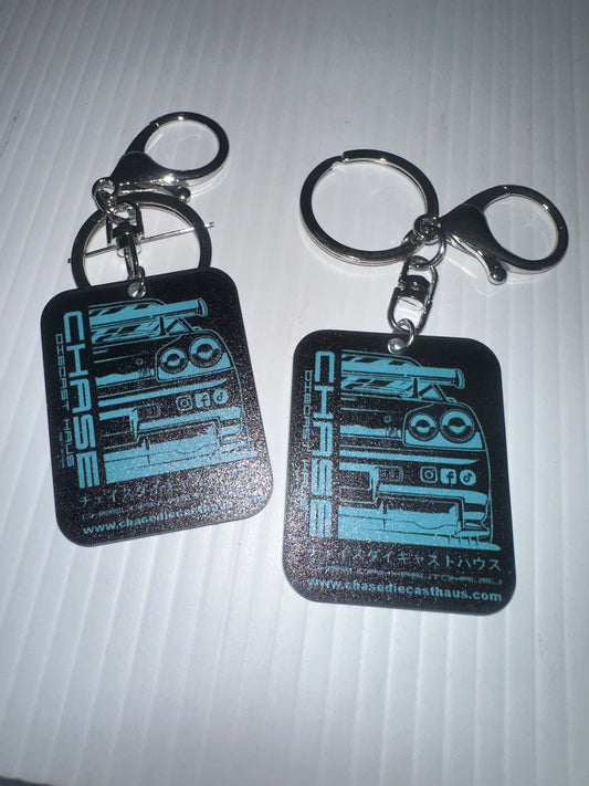 Chase Diecast Haus plastic keyring 5cm x 4cm logo white pink blue