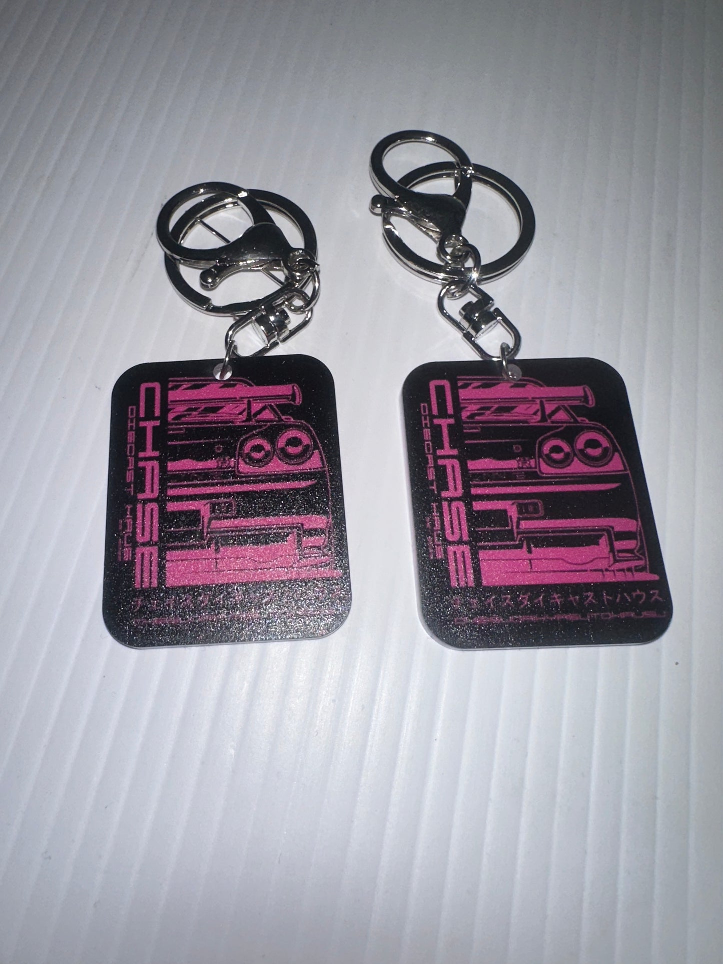Chase Diecast Haus plastic keyring 5cm x 4cm logo  white pink blue